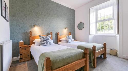 a bedroom with two beds and a window at The Greenhead Hotel in Greenhead