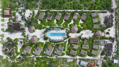 an overhead view of a yard with a pool at Sensations Eco-Chic Hotel in Pwani Mchangani Mdogo