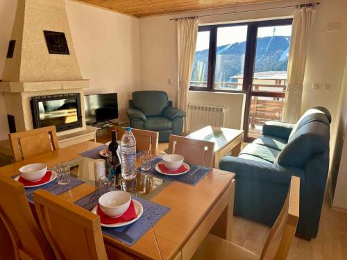 a living room with a table and a dining room at Pamporovo Rhodopi Pearl Apartments - Private Apartments in Pamporovo