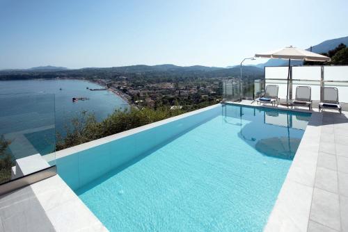 a swimming pool with a view of the water at Cp 5 Bedrooms NL Villas Lucas Clara Pyrgi in Pyrgi