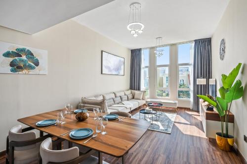 a living room with a table and a couch at Luxury 1 Bedroom Apartment in Discovery Gardens in Dubai