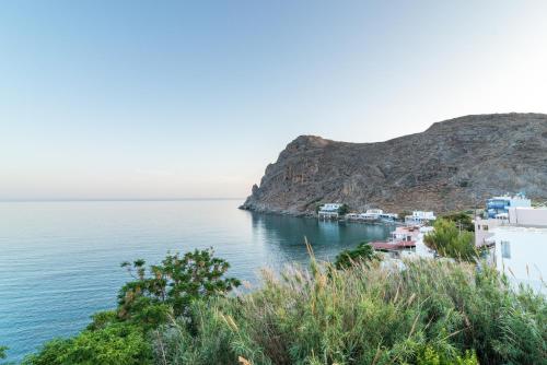 a view of a village on the side of a body of water at Athina Residence in Lentas