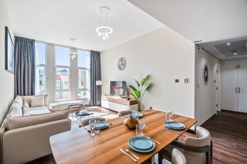 a living room with a table and a couch at Luxury 1 Bedroom Apartment in Discovery Gardens in Dubai