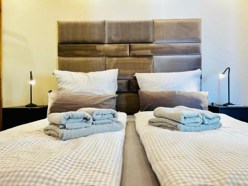 a bedroom with two beds with towels on them at HafenCity-Loft Stralsund in Stralsund