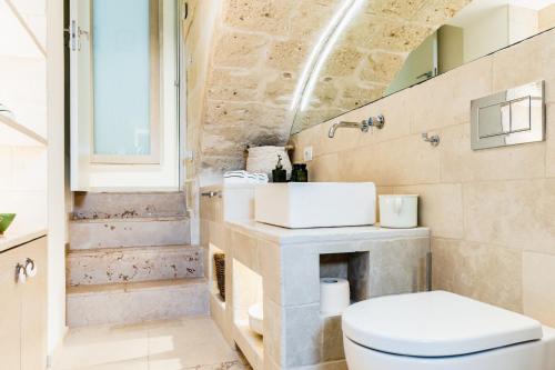 a bathroom with a toilet and a sink at B&b Casa Maredentro in Monopoli