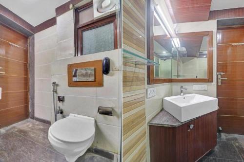 a bathroom with a toilet and a sink at The Royal Galaxy - Sec. 12 Dwarka Metro Station in New Delhi
