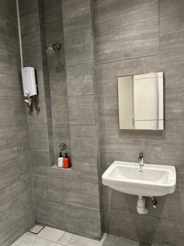 a bathroom with a sink and a mirror at A.R Homestay Riverine Diamond in Kuching
