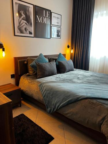 a bedroom with a large bed with blue pillows at Trendy Seaside Escape 2 Bedroom Penthouse in Marsaskala