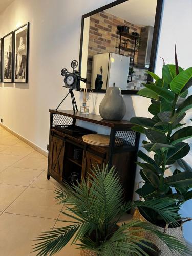 a desk in a room with a plant at Trendy Seaside Escape 2 Bedroom Penthouse in Marsaskala