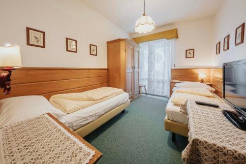 Postel nebo postele na pokoji v ubytování Hotel Menardi