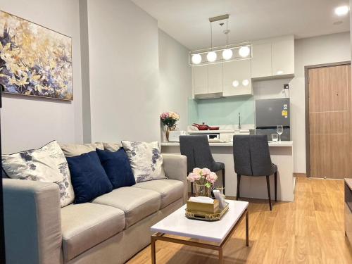 a living room with a couch and a table at Luxury Astra Sky River in Chiang Mai