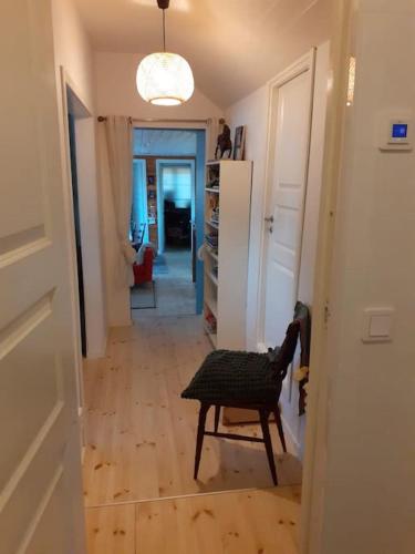 a hallway with a table and a chair in a room at Stunning6B2B views,jacuzzi,sauna in Sättra