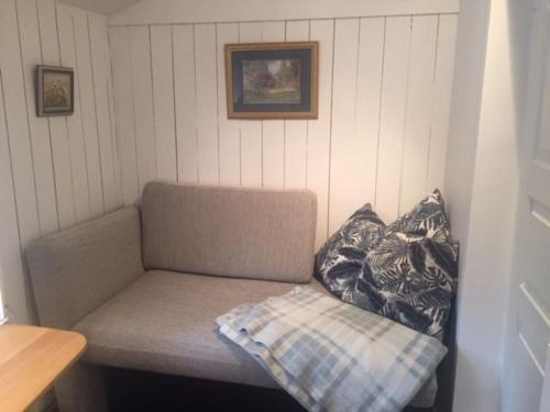 a couch sitting in a corner of a room at Stunning6B2B views,jacuzzi,sauna in Sättra