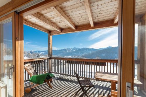 a balcony with a view of the mountains at Hotel Ramsauhof Pool & Wellness Breakfast & Light Dinner Buffet in Ramsau am Dachstein