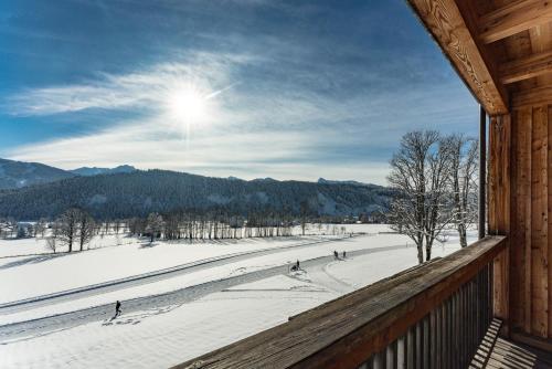 a view of a snow covered field from a cabin at Hotel Ramsauhof Pool & Wellness Breakfast & Light Dinner Buffet in Ramsau am Dachstein