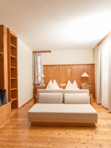 a bedroom with two beds in a room at Hotel Ramsauhof Pool & Wellness Breakfast & Light Dinner Buffet in Ramsau am Dachstein