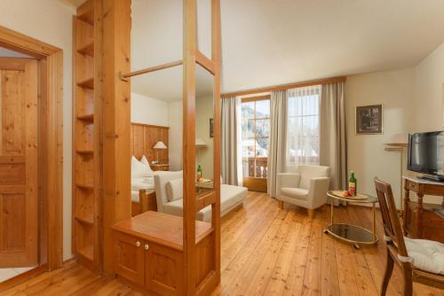 a living room with a large room with at Hotel Ramsauhof Pool & Wellness Breakfast & Light Dinner Buffet in Ramsau am Dachstein