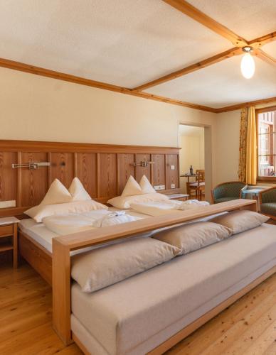 a large bed in a large room with at Hotel Ramsauhof Pool & Wellness Breakfast & Light Dinner Buffet in Ramsau am Dachstein