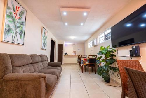 a living room with a couch and a table at Jobos Beach Apartment A-3 in Isabela