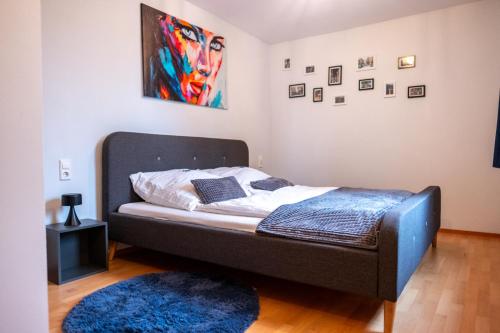 a bed in a room with a blue rug at Klassen Apartments! Schnuckeliges Apartment - mit Balkon -in Bad Saulgau -für vier Personen - 1 OG in Bad Saulgau