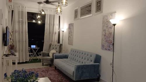 a living room with a couch and two chairs at Benoni 3 Bedroom - Farah Biz Empire Homestay in Papar