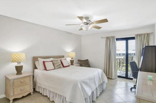 a bedroom with a bed and a ceiling fan at Cotton Bayou Unit 8B in Orange Beach