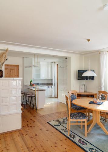 a kitchen and living room with a table and chairs at Hotel Ramsauhof Pool & Wellness Breakfast & Light Dinner Buffet in Ramsau am Dachstein