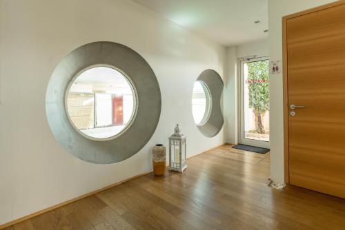 a room with two circular mirrors on the wall at Hotel Ramsauhof Pool & Wellness Breakfast & Light Dinner Buffet in Ramsau am Dachstein