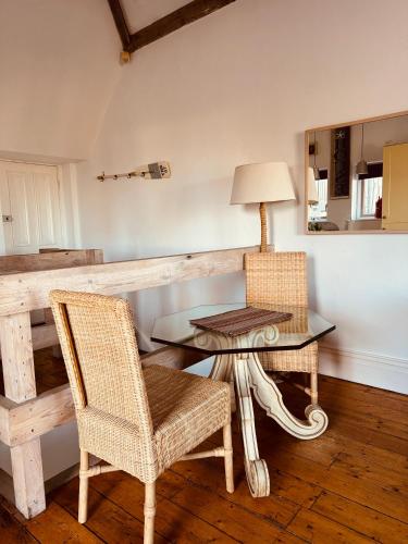 a dining room with a table and two chairs at Longsands Beach Apartment 3 Tynemouth Free Onsite Parking in Tynemouth