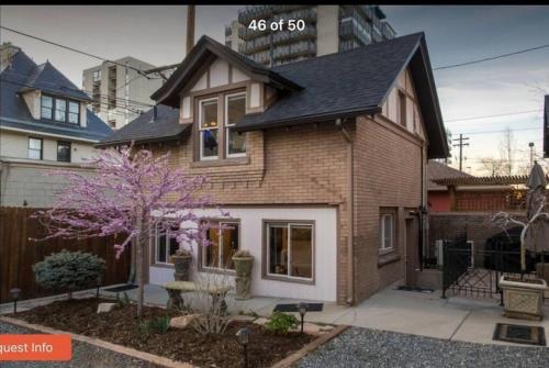 a brown brick house with a black roof at Knight Campbell Carriage House in Denver