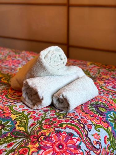 a towel sitting on top of a bed at The Beach Front Apartment, Amazing Frontline Sea Views in Tynemouth