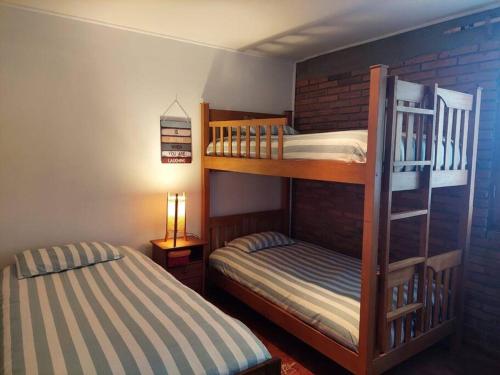 a bedroom with two bunk beds and a lamp at Casa de campo en El convento, Santo domingo in San Antonio