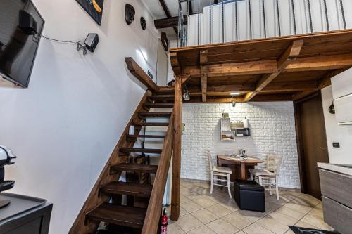a staircase leading up to a kitchen with a table at My hive in Cascina