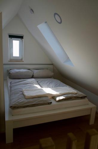 a bed in a room with a roof at Haus Allgäu Wohnung Wertachauen in Türkheim