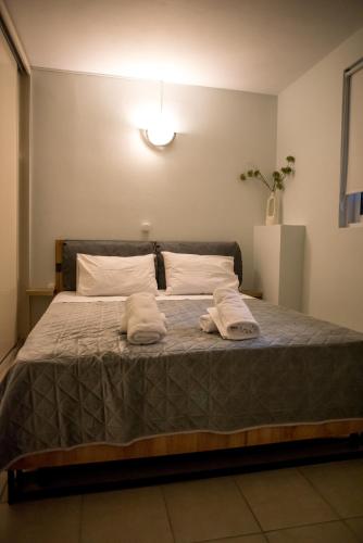 a bedroom with a bed with two towels on it at Leggero in Preveza