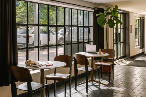 a restaurant with two tables with chairs and a laptop at Sonder The Industrialist in Brooklyn