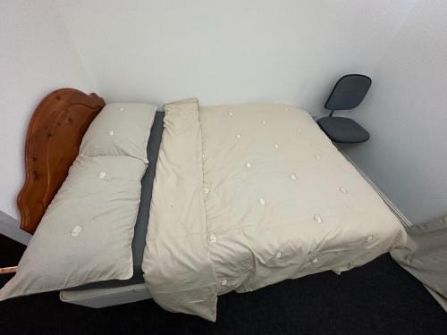 a bed with two pillows on it in a room at Joshmore in Attercliffe