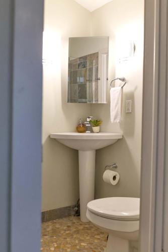 a bathroom with a sink and a toilet at Beautiful Historic Downtown Pensacola Charmer - Hot Tub in Pensacola
