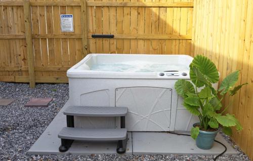a hot tub sitting next to a wooden fence at Beautiful Historic Downtown Pensacola Charmer - Hot Tub in Pensacola