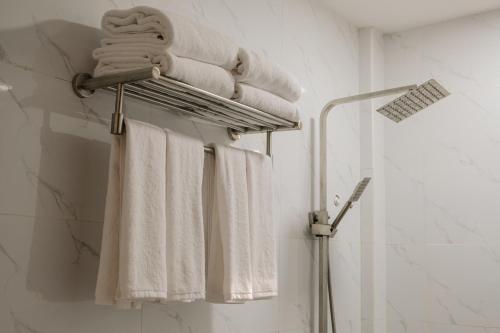 a towel rack with towels on it in a bathroom at Saffire Beach Resort and Glamping in Pagudpud