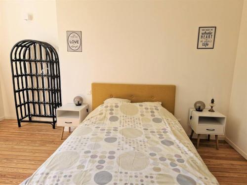 a bedroom with a bed and two night stands at Magnifique Maison de Campagne in Saint-Hellier