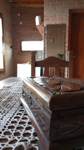 a bed in a room with a table and a chair at Casas de Epoca -Serendipia in Charbonier
