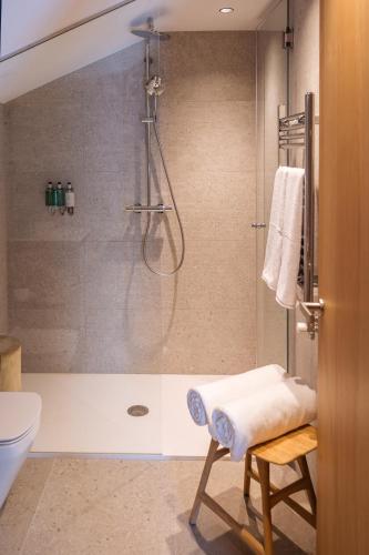 a bathroom with a shower with a glass door at ISARD RESIDENCES & SPA by Vip Residences in El Tarter