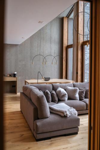 a living room with a couch and a table at ISARD RESIDENCES & SPA by Vip Residences in El Tarter
