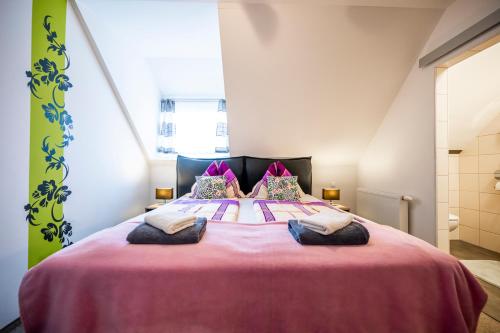 a bedroom with a large bed with two pillows on it at Die Schlafstube - Bed & Breakfast in Zeltweg