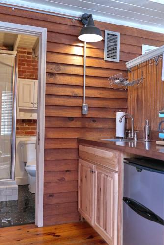 a kitchen with wooden walls and a sink and a toilet at Premier Downtown Loft Building, Just Opened in Pensacola
