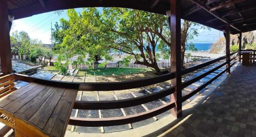 a wooden bench with a view of a park at Farmer’s Cafe Villas in Burgos