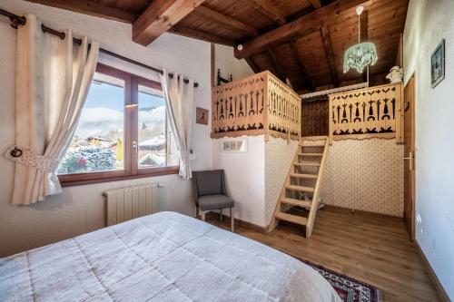 a bedroom with two bunk beds and a chair at Chalet Sun River - 8 pers in Morzine