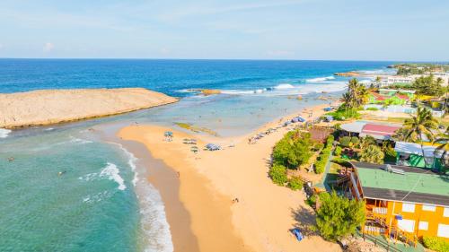 an overhead view of a beach with people in the water at Jobos Beach Apartment A-3 in Isabela