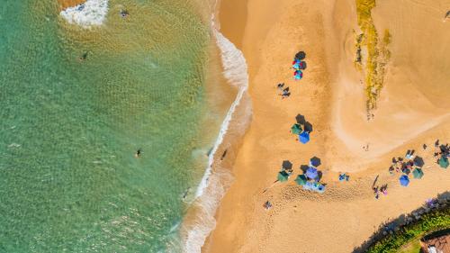 an overhead view of a beach with people and the ocean at Jobos Beach Apartment A-3 in Isabela